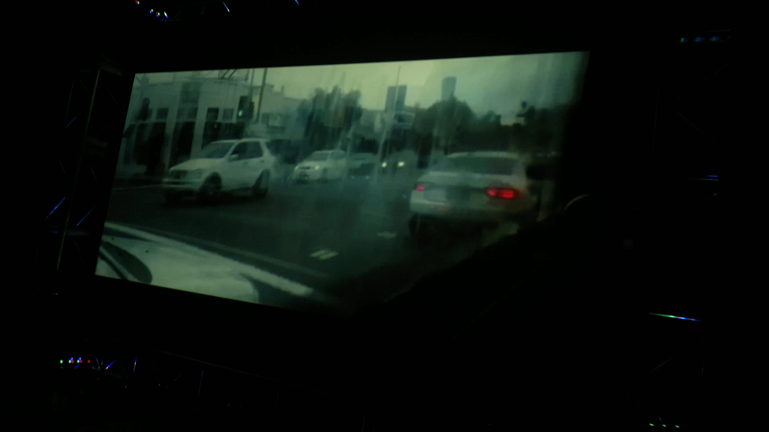 cars on roadway through city traffic in dark night