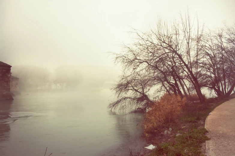 a picture of a lake on a misty day