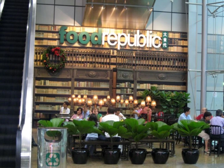 the front entrance of a retail store with potted plants