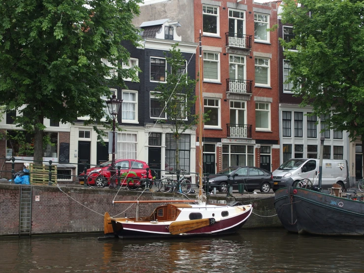 two boats tied to the water by the sidewalk