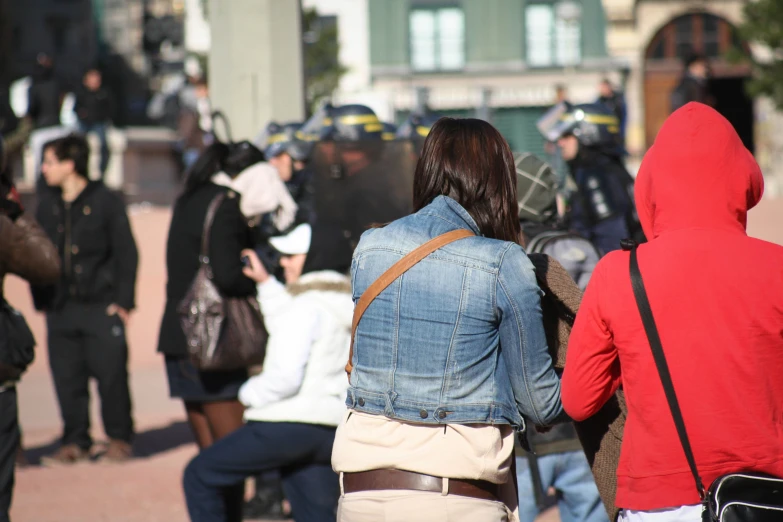 some people standing around a group of dressed in costumes