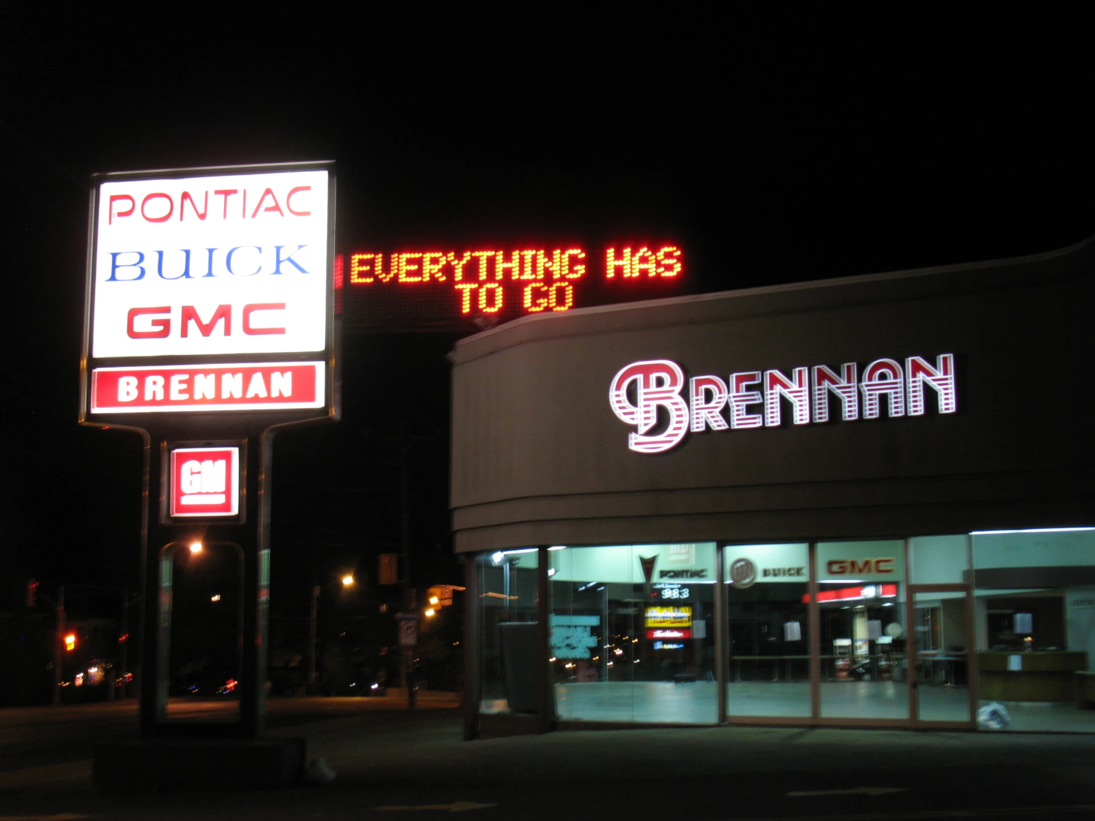 a shopping center at night with different signs