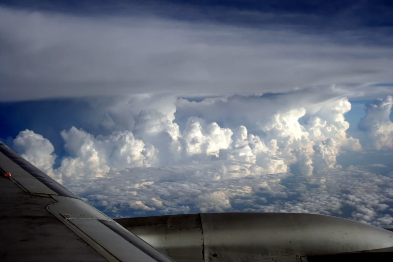 an image of an airplane wing with clouds