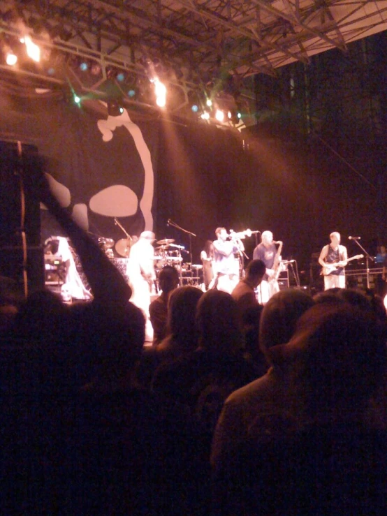 group of people in front of a stage at night