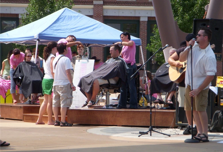 a group of people that are singing into a microphone