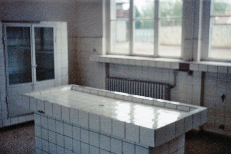 the white tiled counter is by a window