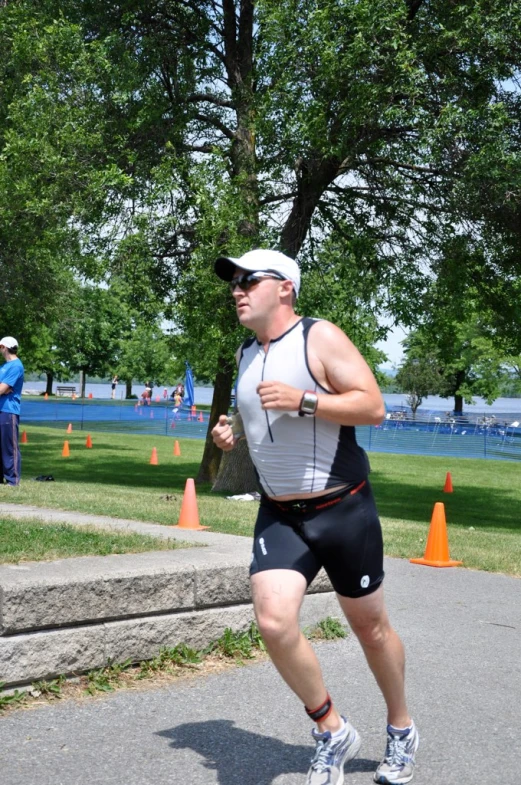 a man running through orange cones at the park