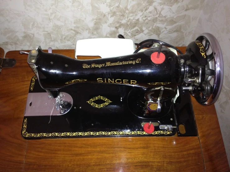 a black singer sewing machine on a table