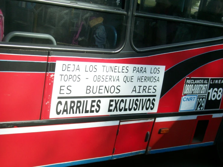 a bus with a sign in spanish parked outside