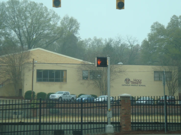 two stop lights in front of a building and cars