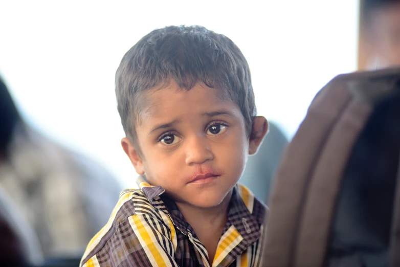 a close up of a young child with a frown