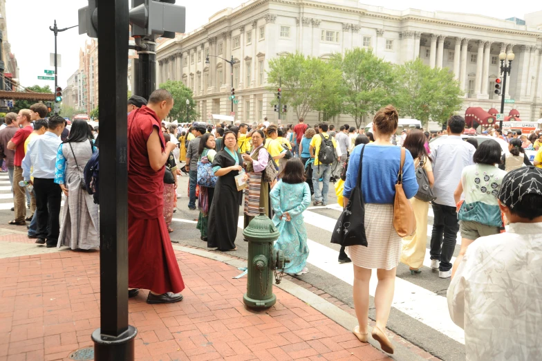 people walking on the sidewalk in the city with red brick