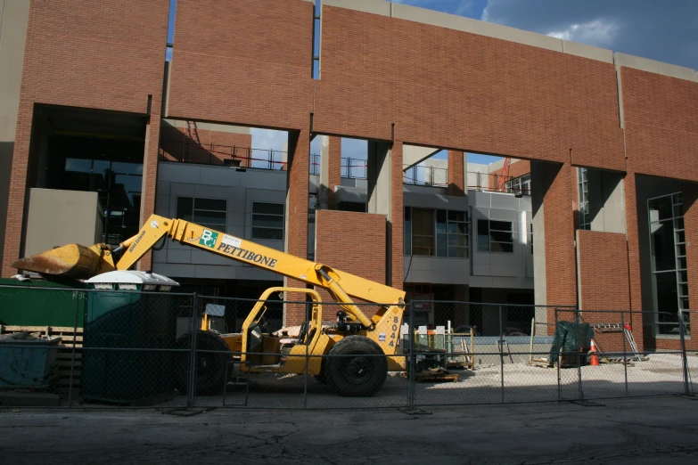 construction machinery parked in front of an apartment building