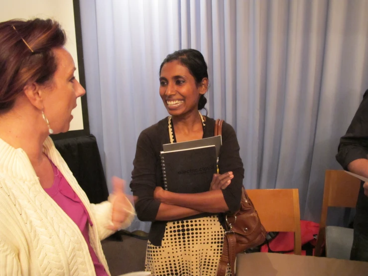 an older woman is speaking with a woman in her lap