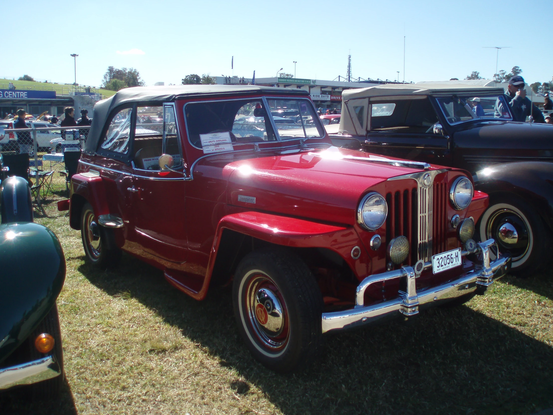 a row of old vehicles at a car show