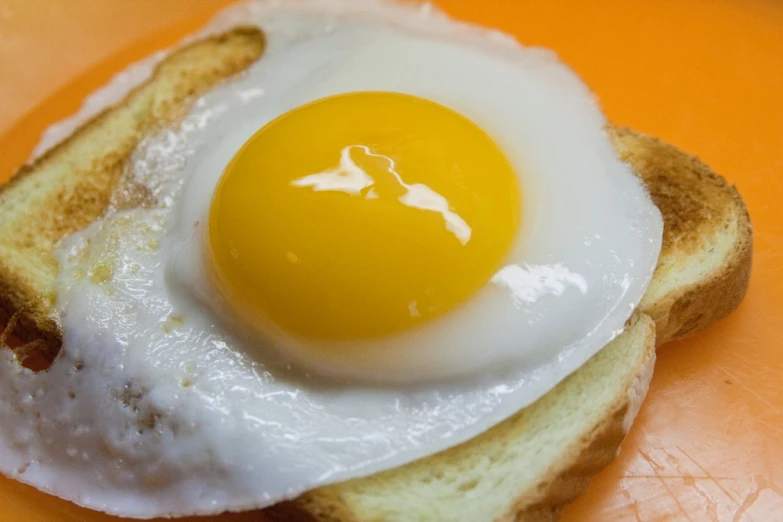 an egg sits on top of a piece of toast