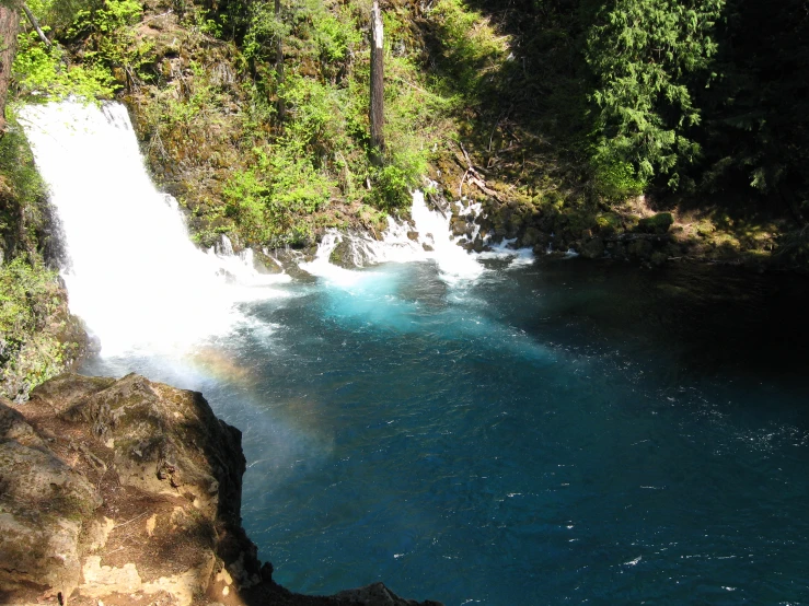 a view of a waterfall near some trees