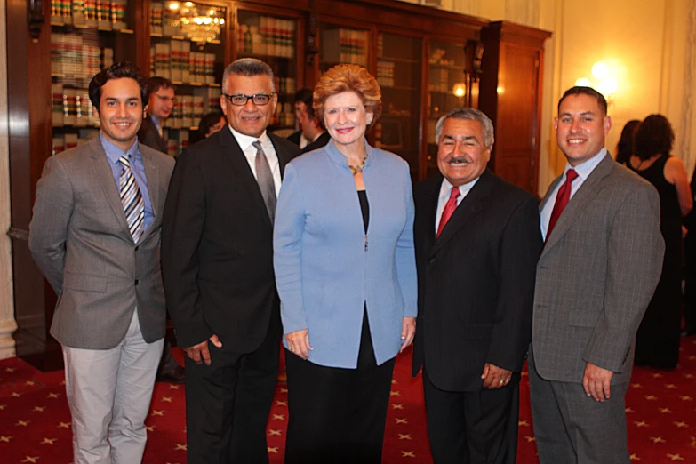 a group of people in business suits posing for a po