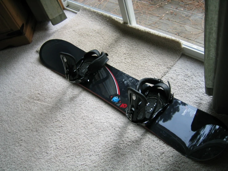 a snow board laying on the floor in front of a window