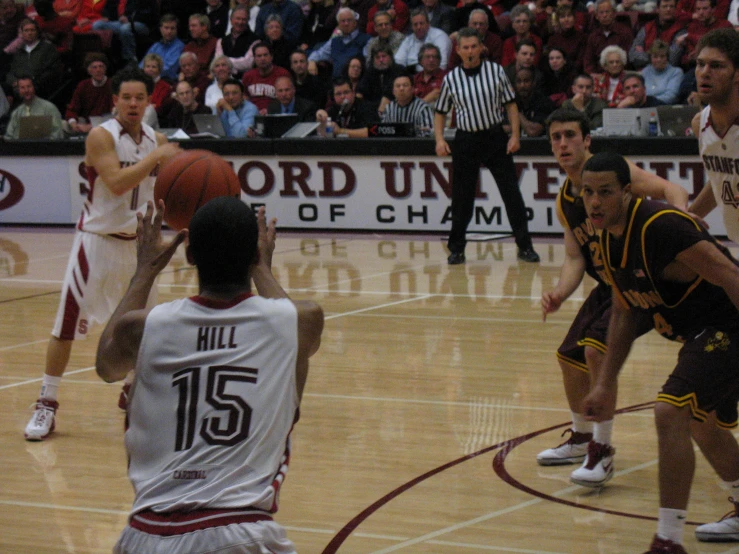 basketball players playing with ball during an indoor game