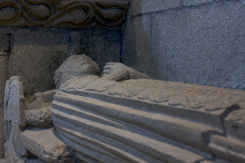 a close up of a large statue of a person laying down