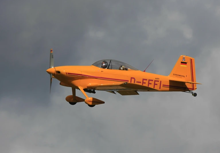 an airplane flying through a cloudy sky with a propeller