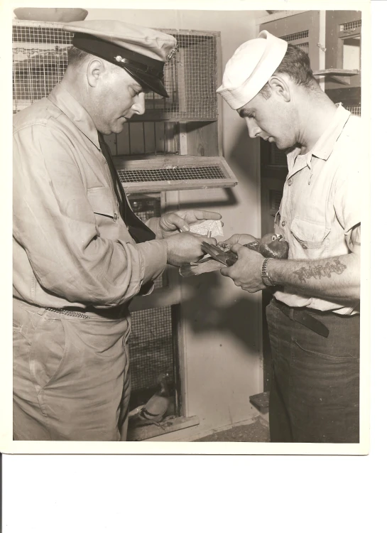 a black and white po of two men working in an oven