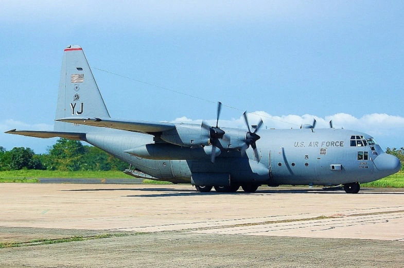 an airplane is parked in the grass on the runway