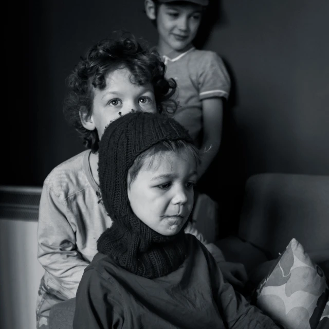 a little boy with a scarf covering his face