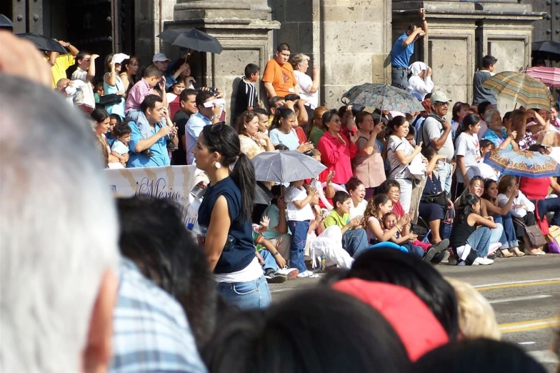 people watching a parade on a city street