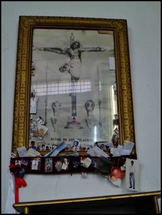 a framed image with pictures on it hangs on the wall next to a fireplace