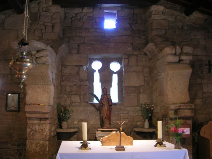 the alter of an old catholic church with candles and a shrine