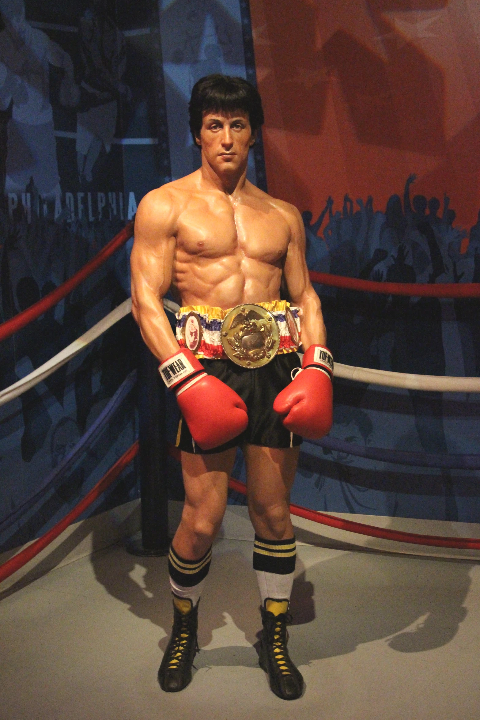 a man wearing boxing gloves and holding a gold award