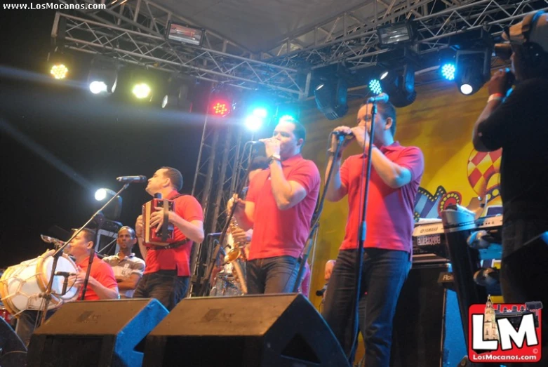 group of men with instruments performing on stage