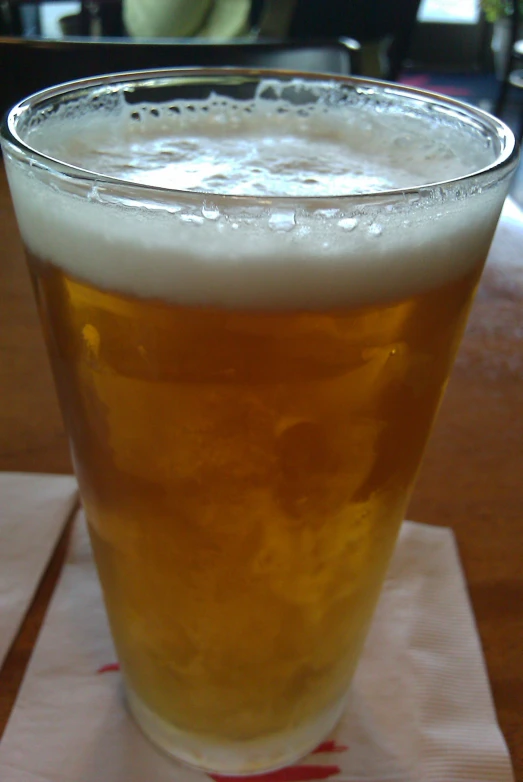 a clear beer glass sits on the table