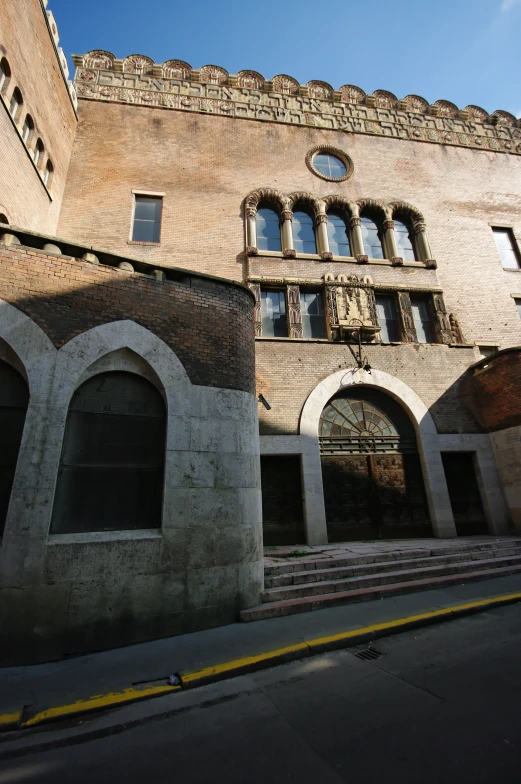 an outside view of a large brick building with doors and windows