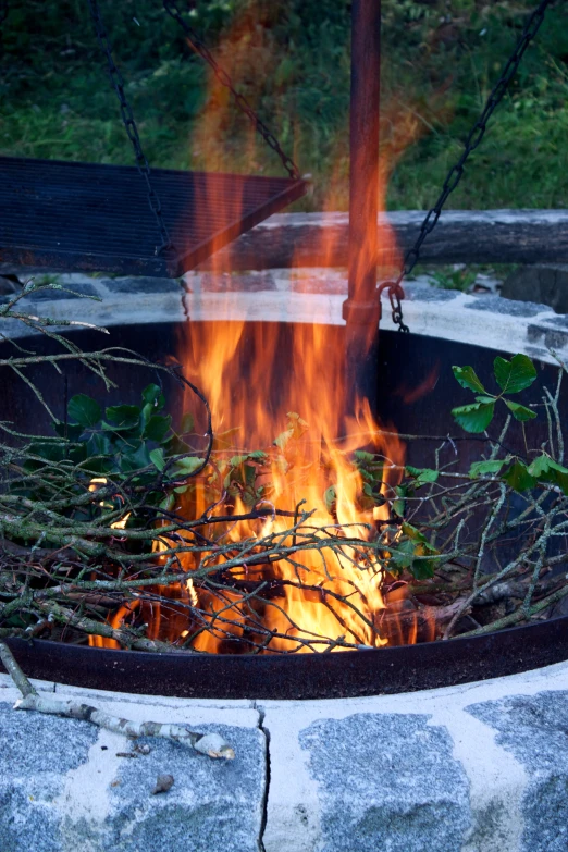 a fire burns in the middle of an outdoor area
