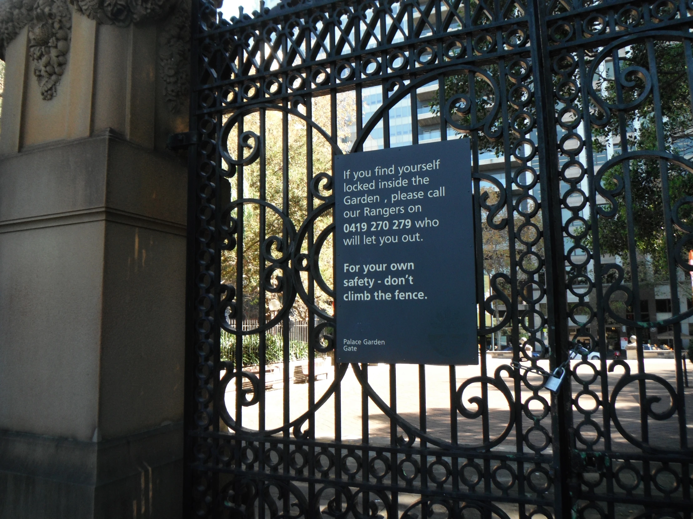 the gate is surrounded by black wrought iron