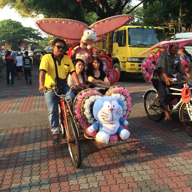 some people on bikes near one man and a dog in a basket