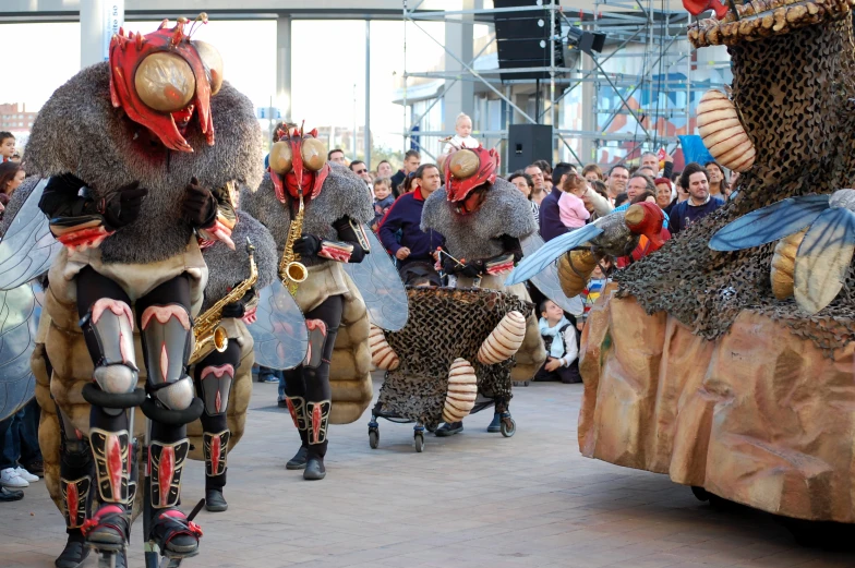 a parade with people riding horses wearing animal costumes