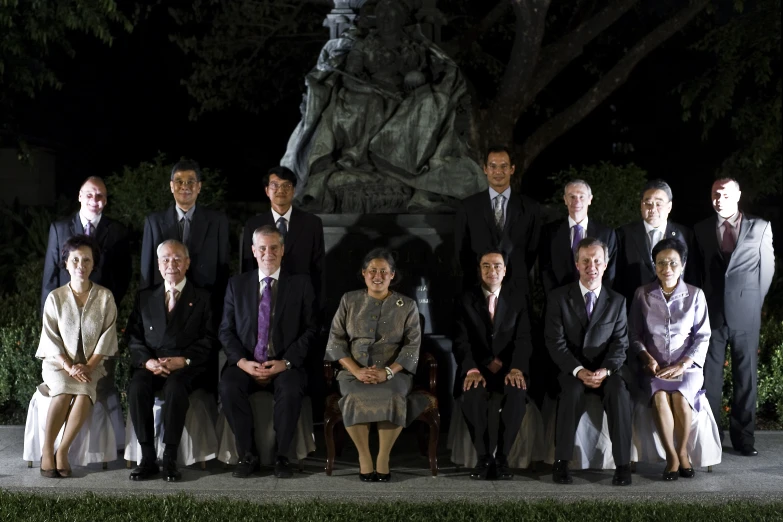 a group of people standing in front of a statue