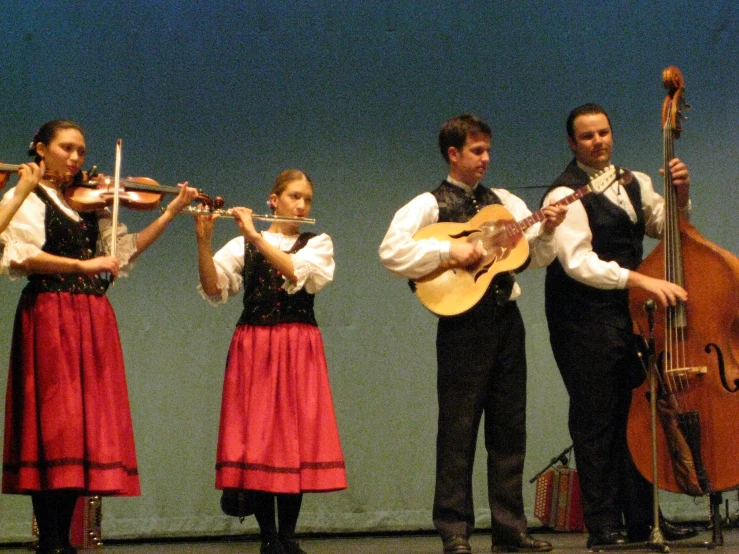 a group of people in costume standing on stage