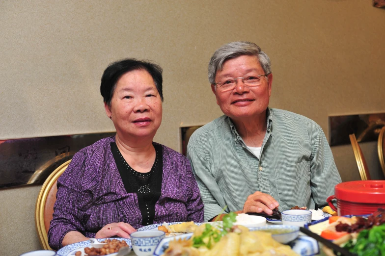 an asian couple enjoying a meal together