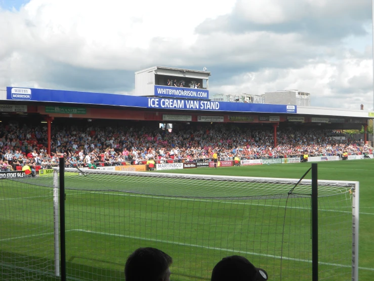 people watching an action match on a soccer field