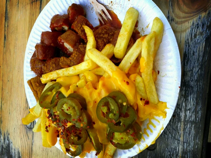  dog and fries are arranged on a paper plate