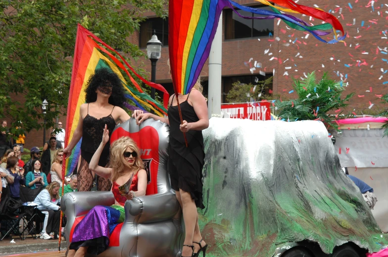 a group of women with colorful flags on float