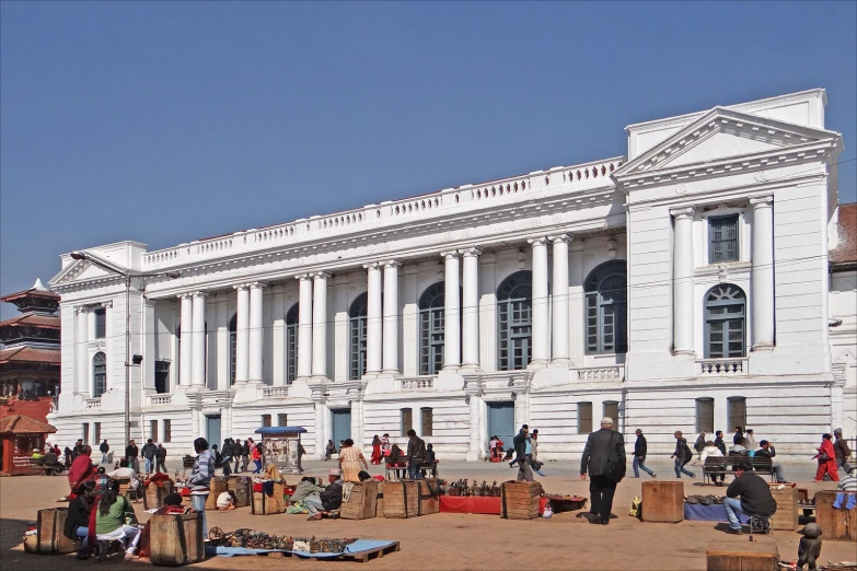 an ornate white building with a group of people