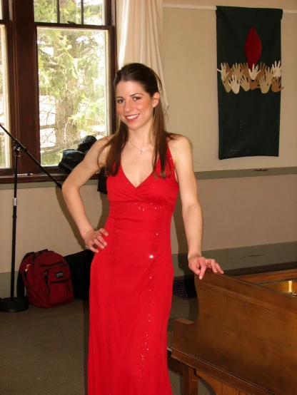 a woman in a red dress is posing for a picture