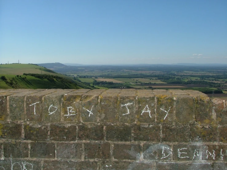 a brick wall that says down today with white writing on it