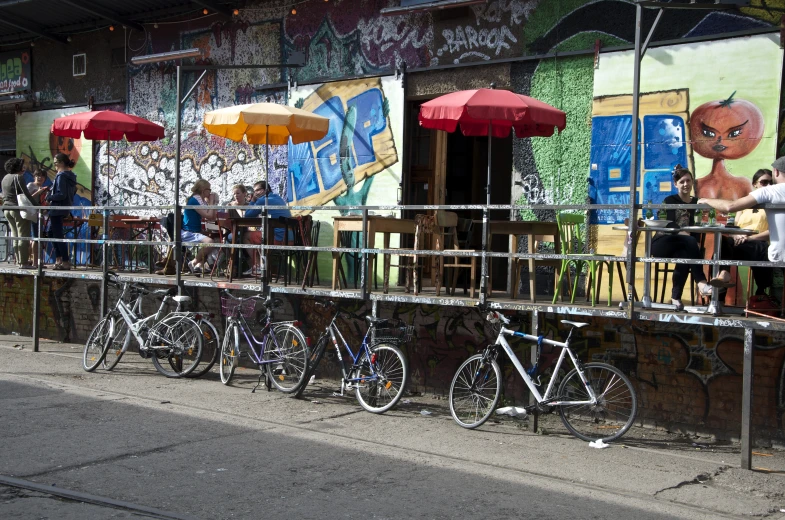 bikes are lined up against a fence outside